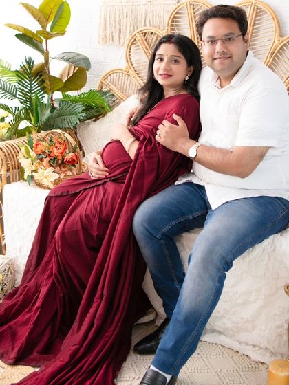 A cozy and loving portrait of the couple seated on our boho-style daybed. Their comfortable embrace and the warm tones of the set create a feeling of home.