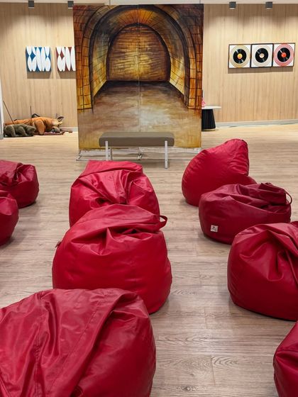 The relaxed and fun setup for a children's storytelling session, with beanbags for the kids to get comfortable. Creating a welcoming environment is key for engaging with children.