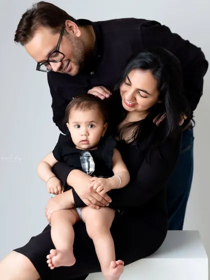 A polished and classic family portrait taken in my studio against a simple backdrop. This style is perfect for creating a timeless piece of art focusing purely on your family's bond.