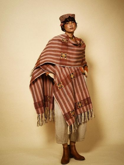 A full-length view of a beautifully styled look, showing how a single statement shawl can define an entire outfit. This is a testament to the power of artisanal fashion.