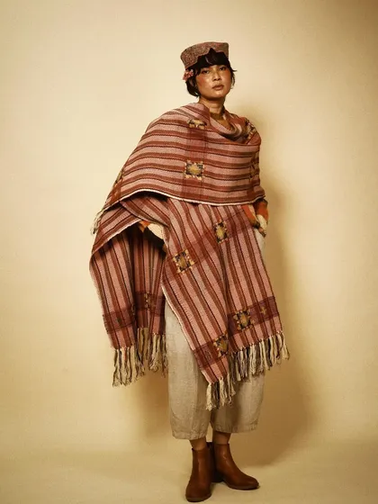 A full-length view of a beautifully styled look, showing how a single statement shawl can define an entire outfit. This is a testament to the power of artisanal fashion.