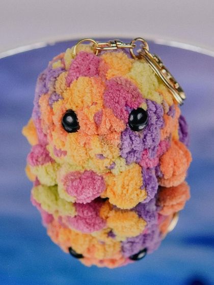 A close-up of my multi-color octopus charm. The fluffy yarn makes it so squishy and fun to have on your bag.