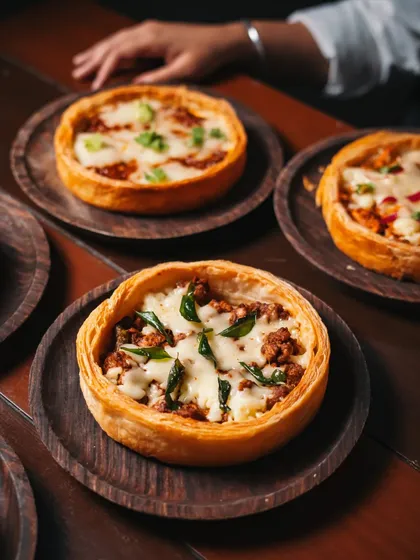 My signature Puffizza 2.0, a culinary tale in every bite. Imagine a flaky, buttery puff pastry, a canvas for globally inspired toppings that travel from the streets of Southeast Asia to the heart of India, all in one dish.