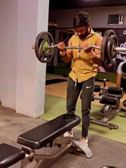 A candid shot during a bicep curl set. Even when not posing, the work shows.