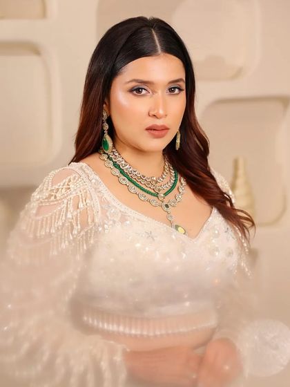 A soft, dreamy shot of the white pearl lehenga. The focus is on the intricate beadwork and the elegant silhouette, making it a showstopper for any event.