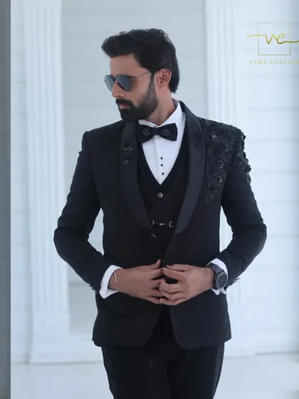 Our bespoke black tuxedo featuring intricate floral embroidery on the shoulders. The tone-on-tone black beadwork creates a subtle yet luxurious texture, perfect for an evening reception.