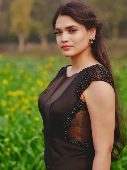 This black evening gown is all about sophisticated details. I crafted this piece with hand-beaded cap sleeves and elegant sheer panels along the sides for a modern, glamorous look. The fitted silhouette is designed to flatter, making it a perfect custom dress for a cocktail party or formal event.