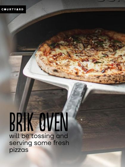 We're set up and ready to serve at a courtyard picnic. Our Ooni oven pop-up is perfect for creating a relaxed, festive atmosphere with fresh, hot pizza on demand.