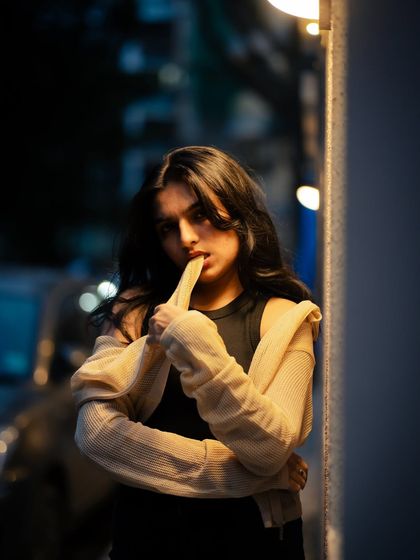 A playful and edgy night portrait. I used the light from a nearby building to create this high-contrast, stylish shot.