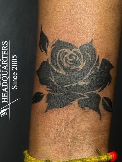 The final result of the wrist cover-up seen in another video. The blackwork rose provides full coverage over the previous design.