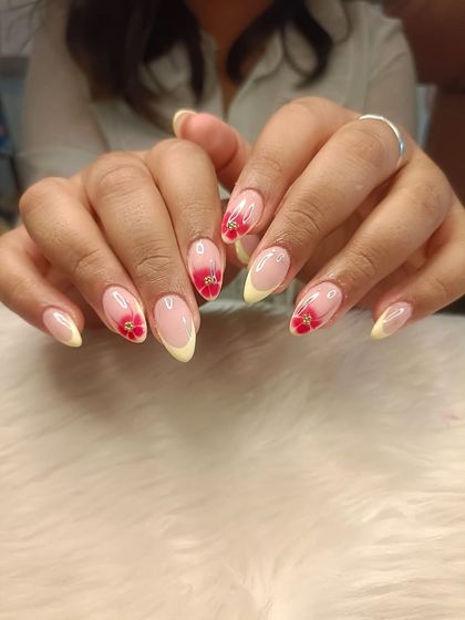 A full view of the yellow French and red blooming flower manicure.