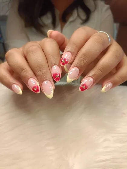A full view of the yellow French and red blooming flower manicure.
