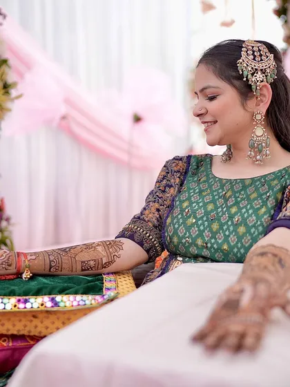 A happy bride admiring her mehandi. The smile on her face as she sees the design taking shape is what makes my work so rewarding.