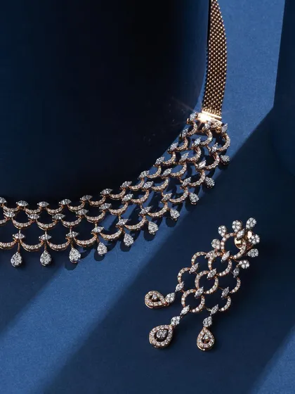 There's something about a clean blue background and sparkling diamonds. This shot for Ranka Jewellers focuses on the intricate, cascading design of the diamond necklace and earrings, with the deep blue silk adding a touch of royalty.