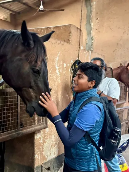 A candid moment between a young rider and his new horse. We believe in fostering a strong connection between horse and rider, which is the foundation for a successful partnership in any equestrian discipline.