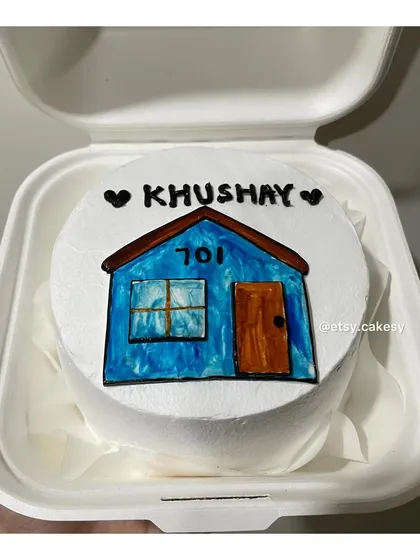 A special housewarming bento cake, featuring a hand-drawn blue house with the apartment number '701'.