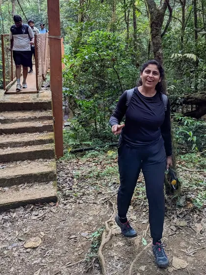 A happy trekker crossing the bridge, full of energy for the climb ahead.