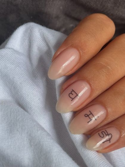 These are called "soap nails" for their super clean, glossy, and natural look. The tiny script adds a personal, delicate touch.