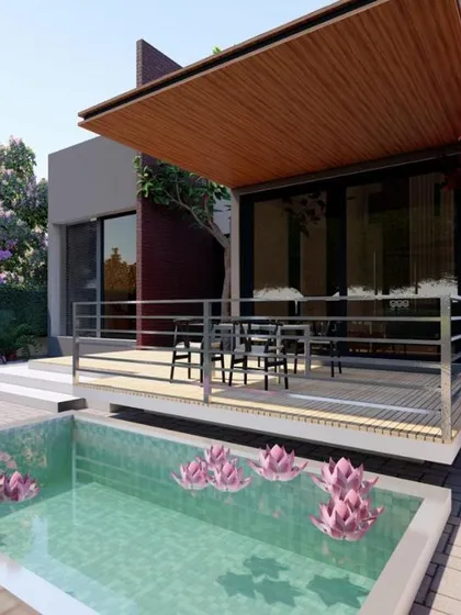 This view highlights the integration of leisure elements into the landscape design. The custom wooden deck provides a functional outdoor seating area, complemented by a serene water feature with aquatic plants, creating a private oasis.