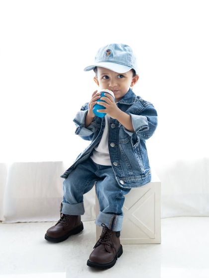 Taking a sip from his prop coffee cup. These little details make the photos unique and memorable.