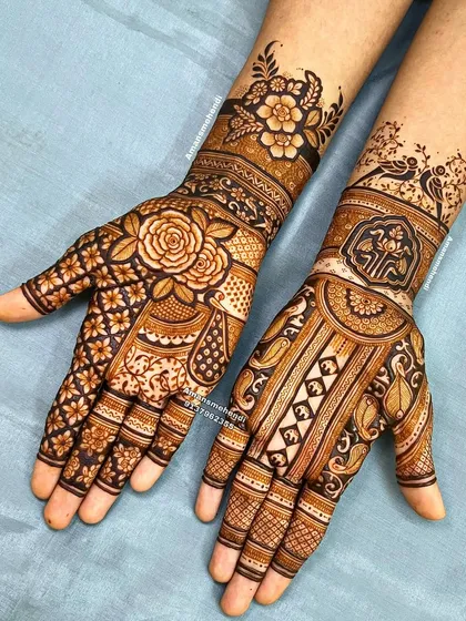 A beautiful bridal set with asymmetrical designs. One hand features a large rose and floral pattern, while the other has a more traditional design with birds and paisleys.