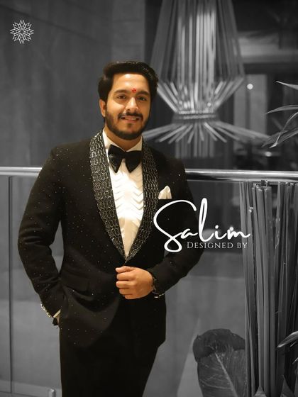 A client looking sharp in a black tuxedo with textured, sparkling lapels. This is a great choice for a cocktail party or a New Year's Eve celebration.