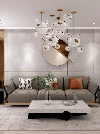 A front view of the maximalist living room, where a neutral sofa is accented with patterned and colored cushions. The circular wall art and bubble chandelier add a playful yet sophisticated touch.