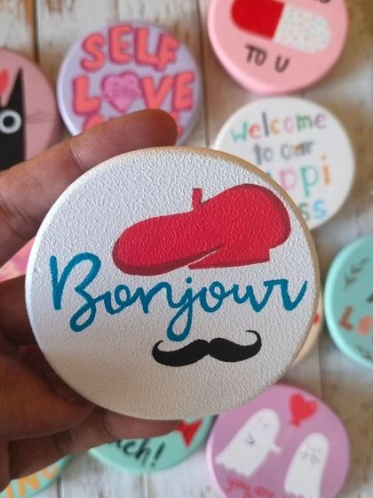 A duplicate of 88, say "Bonjour" with this quirky magnet featuring a red beret and a mustache. A fun little piece of Parisian charm.