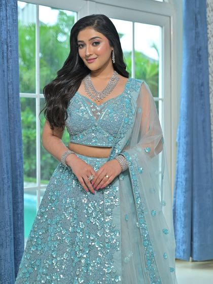 A modern, fashion-forward look featuring a pearl-encrusted gown. The simple diamond drop earrings are the perfect accessory for this statement outfit.