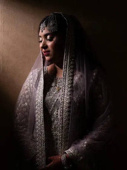 A dramatic bridal portrait using shadow and light to create a moody and elegant look.