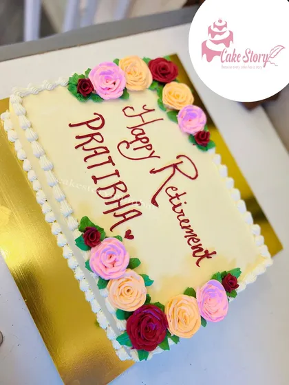 A beautiful floral cake to celebrate a happy retirement. The simple rectangular cake is framed with hand-piped roses in warm colors, offering best wishes for a new chapter.