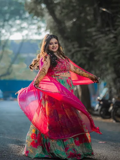 Mehendi days are for fun, color, and twirls. I created this vibrant, playful look to match the bride's joyful energy and her stunning, colorful lehenga.