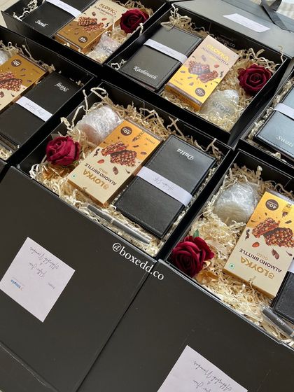 Another view of the client appreciation gifts for ShopSe, showing the careful arrangement of personalized and gourmet items within the sleek black boxes.