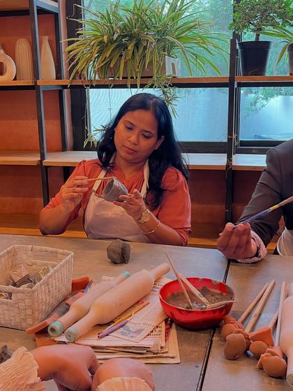 A student carefully carves details into her piece during a hand-building workshop. The focus and creativity in the room are always inspiring.
