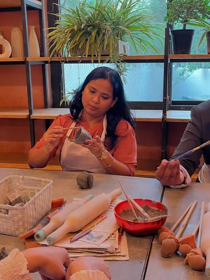 A student carefully carves details into her piece during a hand-building workshop. The focus and creativity in the room are always inspiring.