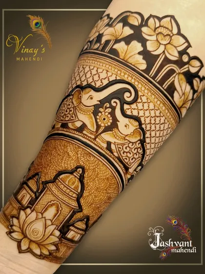 A forearm band featuring a pair of playful elephants under a canopy of lotus flowers. This is a beautiful standalone piece or part of a larger bridal design.