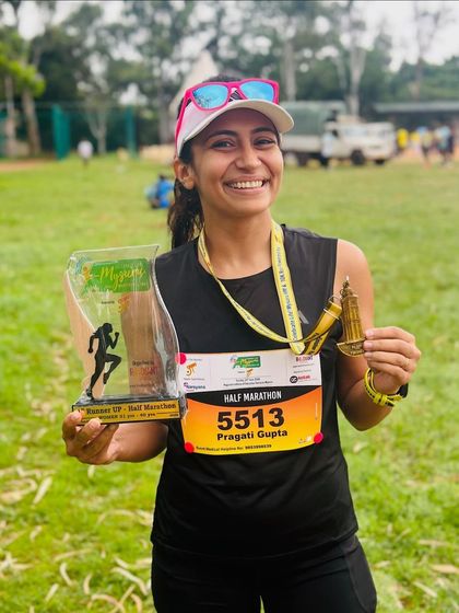 A duplicate of image 23. Pure happiness after securing 2nd place in my age category at the Mysuru Half Marathon. Holding the trophy and medal is a tangible reward for all the hard work.