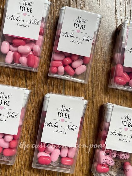 A sweet and clever wedding favor for guests. These tic-tac boxes are customized with a "Mint to Be" label, featuring the couple's names and wedding date.
