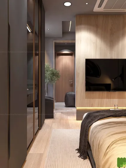 A view down the length of a bedroom, showing the seamless integration of the wardrobe and the TV unit. The wood flooring and paneling add warmth to the modern design.