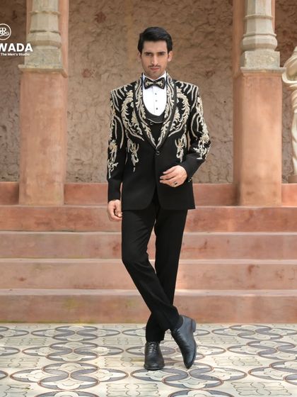 The complete three-piece baroque tuxedo, showcasing the coordinated waistcoat and sharp tailoring. This is a look that speaks of timeless elegance and power.
