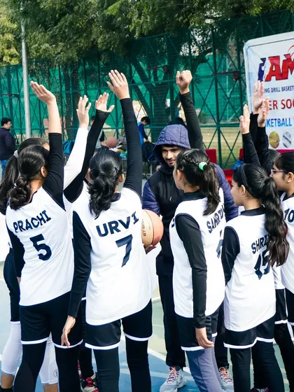 A coach huddles with his team. Teamwork is the beauty of our sport, where five players act as one.