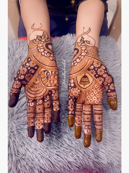 An intricate design perfect for Teej, with peacocks, jhumkas (earrings), and detailed floral work covering both hands.