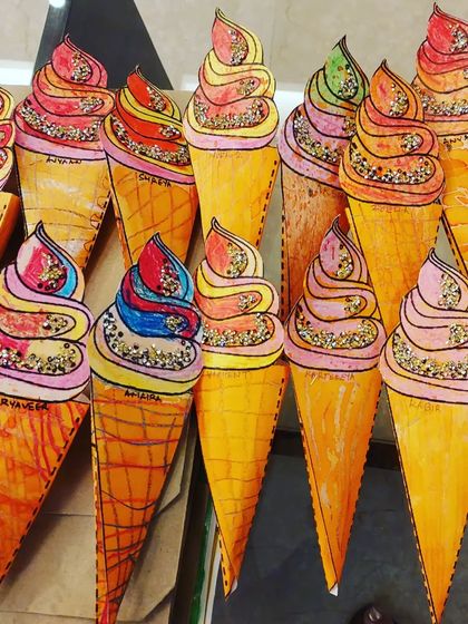 Look at these yummy ice cream cones! This is a fun summer-themed art project by my 3 to 6-year-old students, complete with glitter sprinkles.