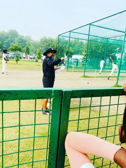 A coach directs players on the field during a trial match. We simulate real match scenarios to test players' game awareness, decision-making, and ability to perform under the watchful eyes of selectors.