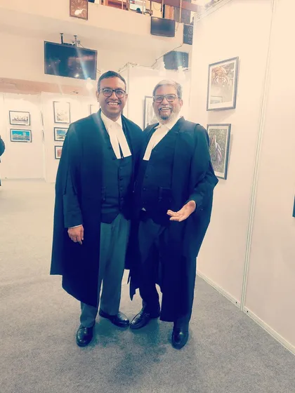 Sharing a light-hearted moment with a colleague at a legal event. A strong legal community is built on both serious work and collegial relationships.