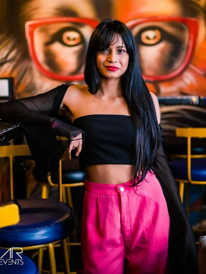 A guest posing against a colorful graffiti wall.