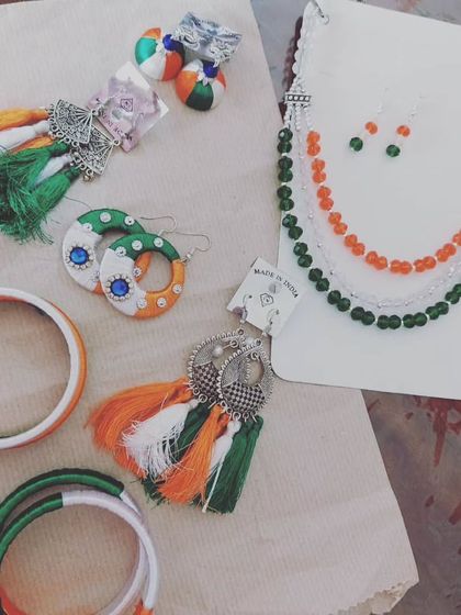 A flat lay of the custom tricolor jewellery I created for the Independence Day performance. It includes beaded necklaces, tassel earrings, and bangles in saffron, white, and green.
