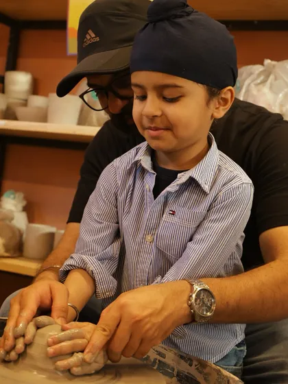 Pottery is an activity for all ages, and it's wonderful to see fathers and sons bonding over the wheel. I guide them step by step, making it a fun and successful experience for even the youngest potters.