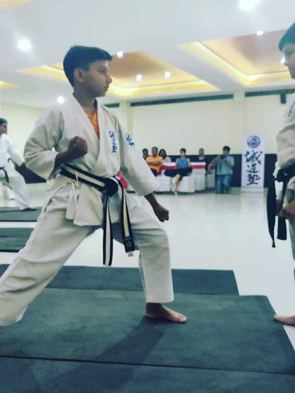 The same student transitions into a ready stance, demonstrating focus and preparation for the self defense drill.