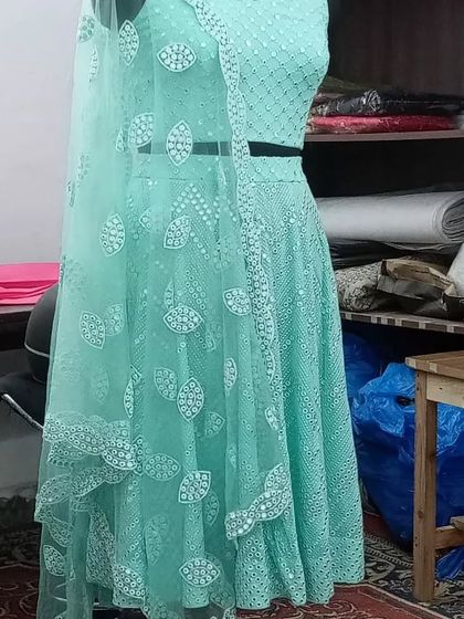 The mint green Chikankari lehenga on a mannequin in my workshop. You can see the detailed embroidery on the skirt and the matching net dupatta.